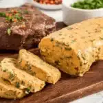 Cowboy Butter Recipe served warm beside grilled steak and herbs.